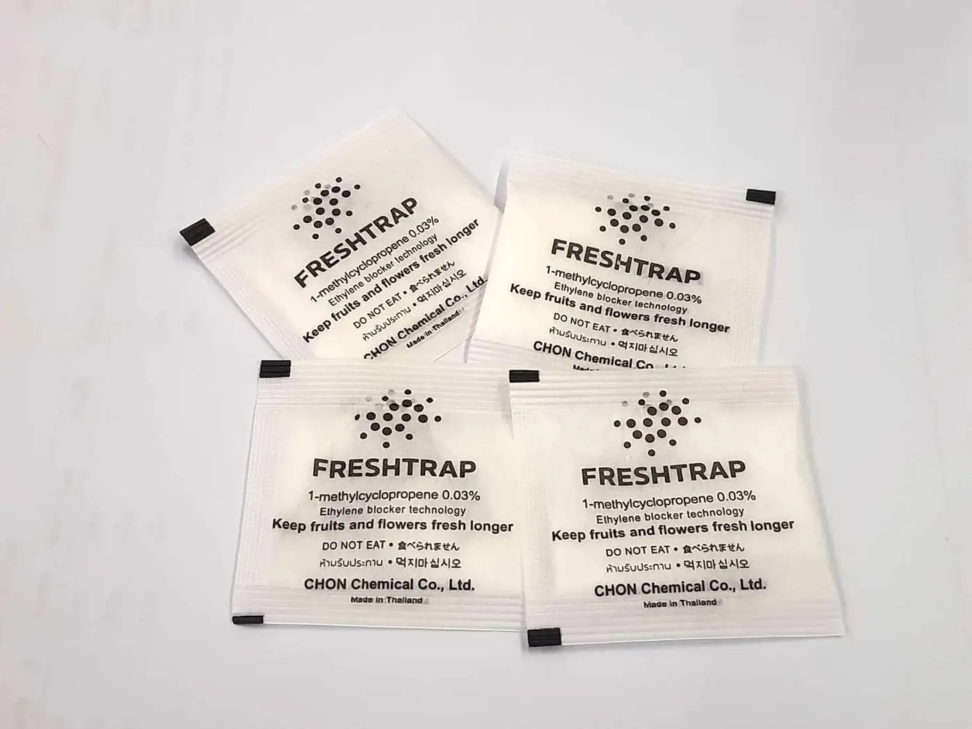 Four white FreshTrap 0.03% 1-MCP sachets printed with the FreshTrap mark.